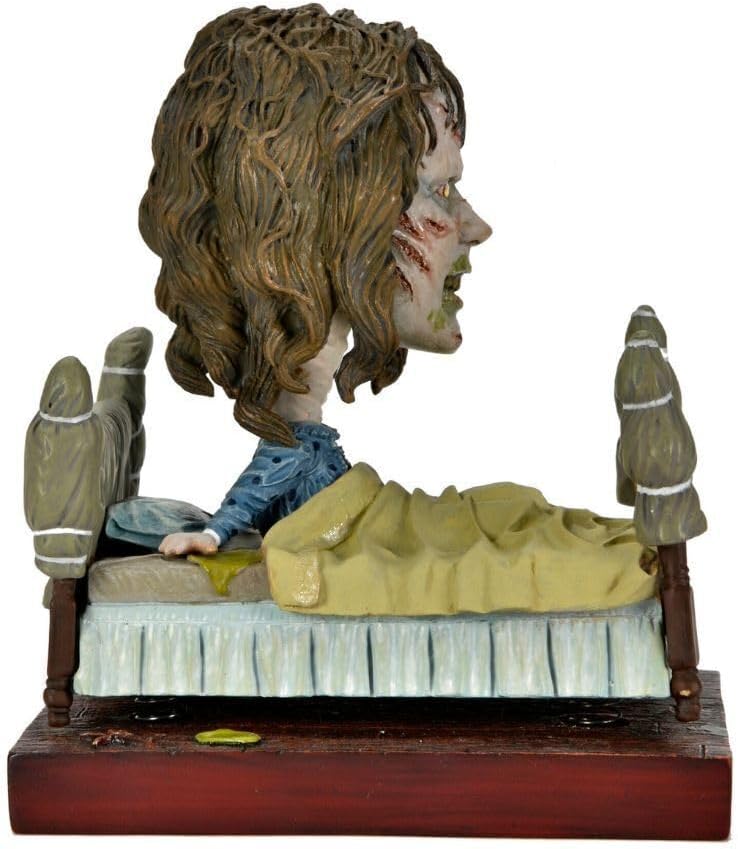 NECA Head Knocker El Exorcista - Regan in Bed (Regan en cama)